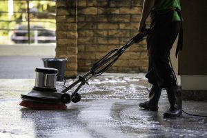 A Man Worker Cleaning The Floor With Polishing Machine